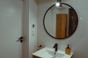 a bathroom with a sink and a mirror at Domek na szlaku in Szklarska Poręba