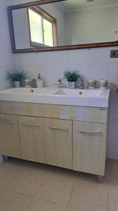 a bathroom with a large sink and a mirror at Casa Algarrobo in Algarrobo