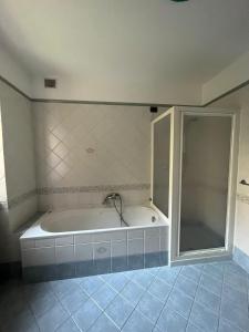 a bath tub in a bathroom with a shower at Casa Romy in Rovere della Luna