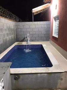 una piscina de agua con una fuente en Condômino indiana Jones, en Itanhaém