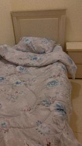 an unmade bed with a blanket on top of it at شقة تنويه ليست للايجار in Al Khobar