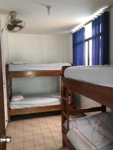 a room with three bunk beds and a window at El Sol Dorado in Tonsupa