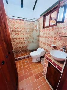 a bathroom with a toilet and a sink at Cabaña Casa Cantabria in Villa de Leyva +39 photos