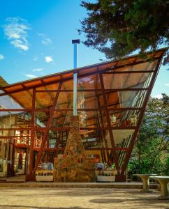 a building with a glass facade with benches in front at Ecoterra Inka Lodge in Quillabamba