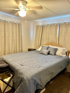 a bedroom with a large bed and a ceiling fan at Channel Escape in Coldwater