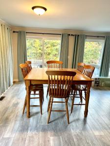 a dining room with a wooden table and chairs at Channel Escape in Coldwater