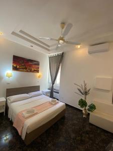 a bedroom with a bed and a ceiling fan at Hotel Castelfidardo in Rome