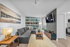 a living room with a couch and a tv at Chic 1BR Condo in Coal Harbour in Vancouver