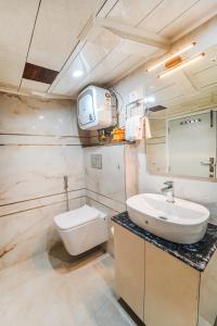 a bathroom with a sink and a toilet at Singhs BnB by Lazy Getaways in Shimla