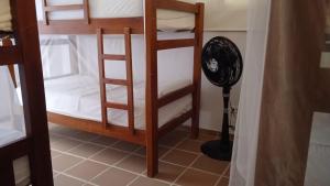 a room with two bunk beds and a fan at Hostal Casa en la Ciénaga in San Onofre