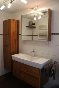 a bathroom with a sink and a mirror at Ferienhäuschen Brohlbachtal 