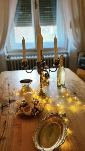 a table with candles and a plate on a table with lights at No.8: Lovely & Cosy 3-room Heart of the City in Timişoara