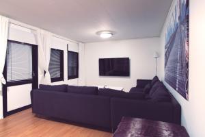 a living room with a couch and a tv at SBC Guest House in Pajala