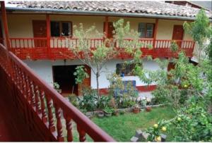 a balcony of a house with trees and plants at Hospedaje La Ñusta in Ollantaytambo