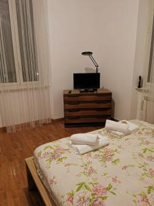 a bedroom with a bed and a tv on a dresser at La Casetta di Benedetta in Rome +3 photos