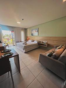 a large room with a bed and a couch at Apartamento em Barra Grande, Piauí in Cajueiro +18 photos