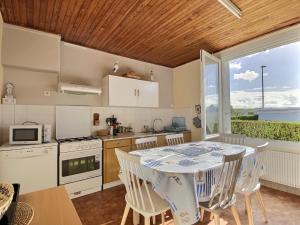 a kitchen and dining room with a table and chairs at Maison d'Ys à 500 m de la plage in Saint-Nic +37 photos