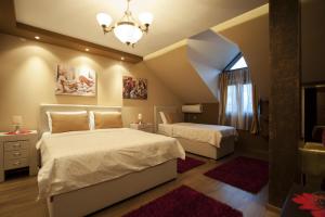 En eller flere senge i et værelse på Benvenuti Apartments