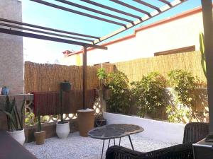 an outdoor patio with a pergola and potted plants at The cactus house in Casablanca