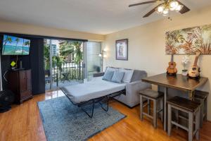 a living room with a couch and a table at Royal Aloha Waikiki Beach in Honolulu