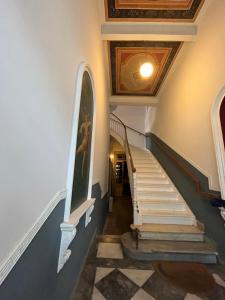 a staircase in a building with a ceiling at Αρχοντικό Κάββουρα 1890 in Nafpaktos