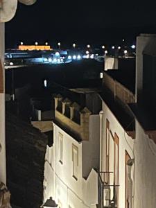 a view of a city at night with buildings at CASA MARTIN in Hornachuelos +5 photos