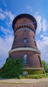 a brick tower with a window on top of it at Wieża Gniezno Apartament KRÓL in Gniezno