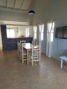 a kitchen and dining room with a table and chairs at Cheriquendi in Quequén