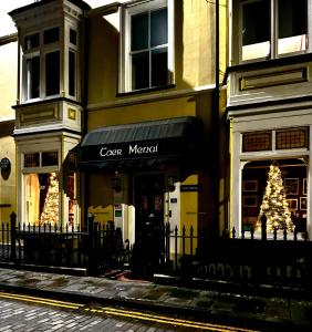 a store with a christmas tree in front of a building at Caer Menai in Caernarfon