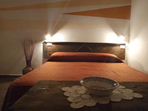 a bedroom with a bed with a bowl on a table at Bed And Breakfasts LA CASETTA in Terranova di Pollino +45 photos