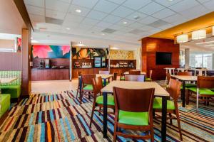 une salle à manger avec des tables, des chaises et une télévision dans l'établissement Fairfield Inn & Suites by Marriott Pecos, à Pecos