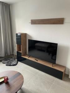 a living room with a large flat screen tv at Paris3 in Oberhausen