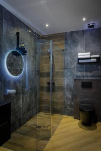 a bathroom with a glass shower with a toilet at Signature Apartments in Blackpool