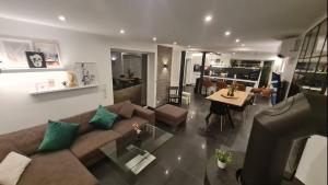 a living room with a couch and a table at Business Apartment Loft nähe Bonn 3 SZ in Königswinter