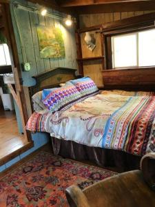 um quarto com uma cama e uma cadeira num quarto em The Hunter Cabin at Sky Hollow em Rochester