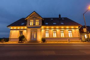 a house with lights on the front of it at Pension Sonne Appartements in Minden