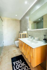 a bathroom with a sink and a toilet and a mirror at Appartement Duplex G1 in Casablanca