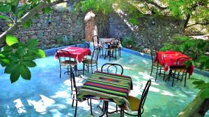 a group of tables and chairs sitting in a pool at Zaratoustra in Imlil