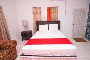 a bedroom with a large bed and a couch at Suzette Guesthouse Accommodations in St Mary