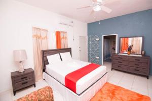 a bedroom with a bed and a dresser and a couch at Suzette Guesthouse Accommodations in St Mary