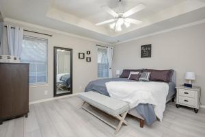 a bedroom with a bed and a ceiling fan at Spacious Brick House 3BR 2BA A+ in Denton