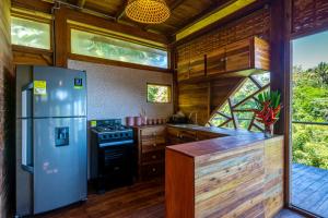 a kitchen with a stainless steel refrigerator and wooden cabinets at Paraiso Ahimsa in Buritaca