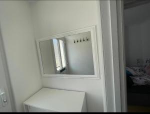 a bathroom with a mirror on the wall at Samarlon Home Saxton in Gillingham