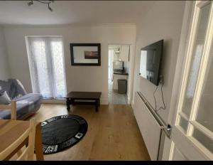 a living room with a couch a table and a television at Samarlon Home Saxton in Gillingham