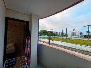 a room with a balcony with a view of a baseball field at Praia do Bessa, Caribessa - Quarto Privativo - Conforto, Paz e Sossego, excelente para descansar, trabalhar ou estudar in João Pessoa
