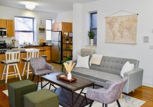 a living room with a couch and a table at Prime Location! 3BRGem near University of Chicago in Chicago