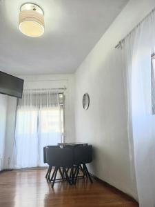 ein Esszimmer mit einem Tisch, Stühlen und einem Fenster in der Unterkunft Apartamento esq Rambla y centrico in Montevideo