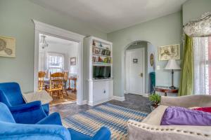 a living room with blue chairs and a table at Endeavour House in Newport