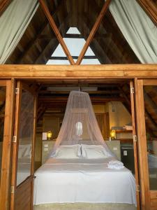 a bed with a mosquito net in a room at ADA MARINA, hotel campestre con la mejor vista a Cartagena in Turbaco