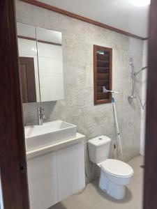 a bathroom with a white toilet and a sink at Vila Del Mare Oceanfront Villas in Port Vila +108 photos